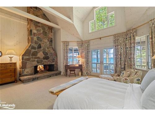 3-4916 Muskoka Road 169, Muskoka Lakes, ON - Indoor Photo Showing Bedroom With Fireplace