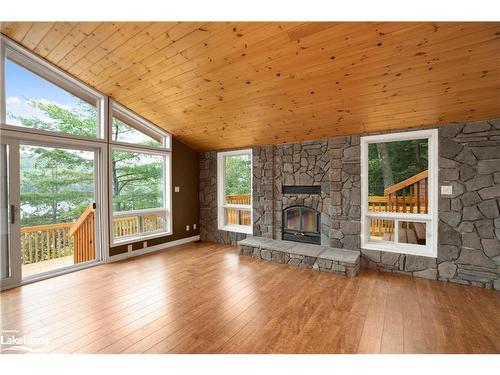 16 Mountain Basin, Mcdougall, ON - Indoor Photo Showing Living Room With Fireplace