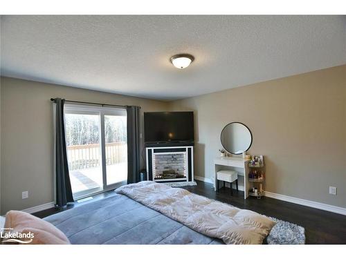 77 Constance Boulevard, Wasaga Beach, ON - Indoor Photo Showing Bedroom With Fireplace