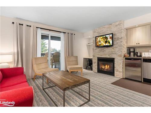 55-207-1235 Deerhurst Drive, Huntsville, ON - Indoor Photo Showing Living Room With Fireplace
