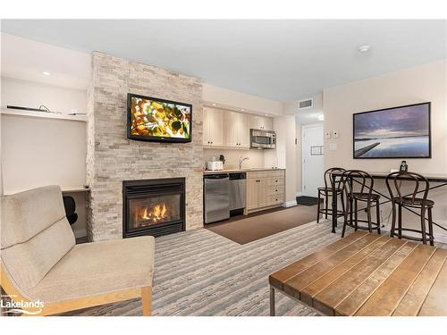 55-207-1235 Deerhurst Drive, Huntsville, ON - Indoor Photo Showing Living Room With Fireplace