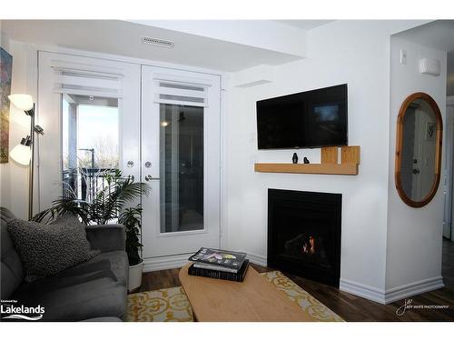300-2 Cove Court, Collingwood, ON - Indoor Photo Showing Living Room With Fireplace