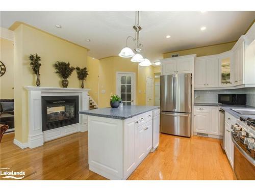 91 Mary Jane Road, Tiny, ON - Indoor Photo Showing Kitchen With Fireplace
