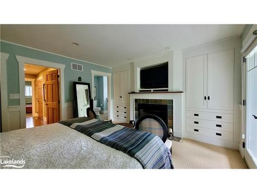 V9 W5-1020 Birch Glen Road, Baysville, ON - Indoor Photo Showing Bedroom With Fireplace