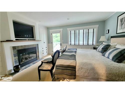 V9 W5-1020 Birch Glen Road, Baysville, ON - Indoor Photo Showing Bedroom With Fireplace