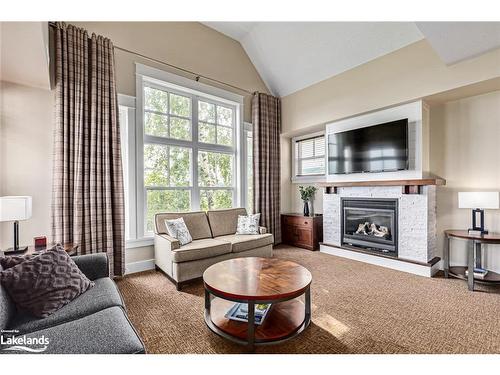 206-115 Fairway Court, The Blue Mountains, ON - Indoor Photo Showing Living Room With Fireplace