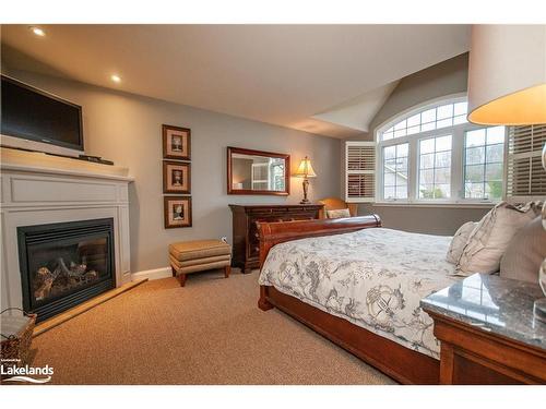 Carling 4, W10-3876 Muskoka Road 118 West, Port Carling, ON - Indoor Photo Showing Bedroom With Fireplace