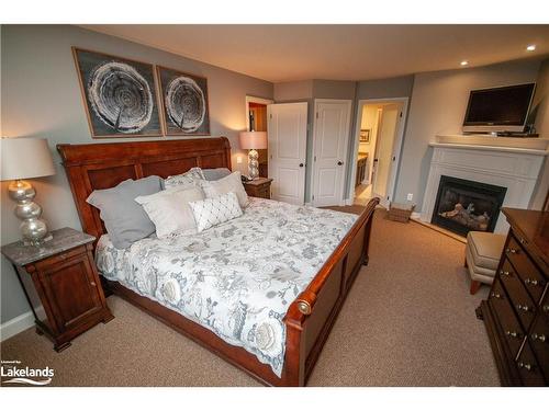 Carling 4, W10-3876 Muskoka Road 118 West, Port Carling, ON - Indoor Photo Showing Bedroom With Fireplace