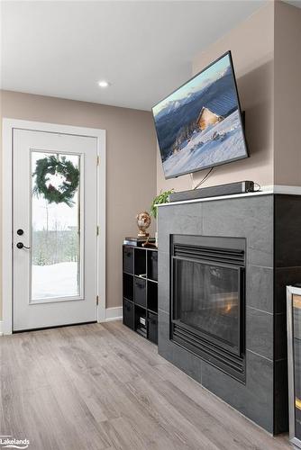 102-4 Tree Tops Lane, Huntsville, ON - Indoor Photo Showing Living Room With Fireplace