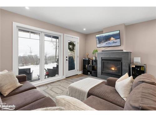 102-4 Tree Tops Lane, Huntsville, ON - Indoor Photo Showing Living Room With Fireplace