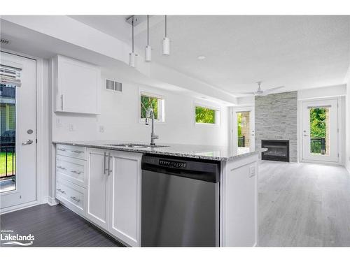 101-8 Brandy Lane Drive, Collingwood, ON - Indoor Photo Showing Kitchen With Fireplace