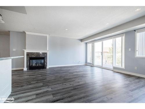 205-4 Beck Boulevard, Penetanguishene, ON - Indoor Photo Showing Other Room With Fireplace