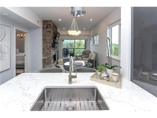 402-16 Beckwith Lane, The Blue Mountains, ON - Indoor Photo Showing Kitchen With Fireplace