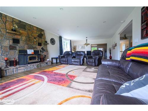 11 Gibson Road, Emsdale, ON - Indoor Photo Showing Living Room With Fireplace