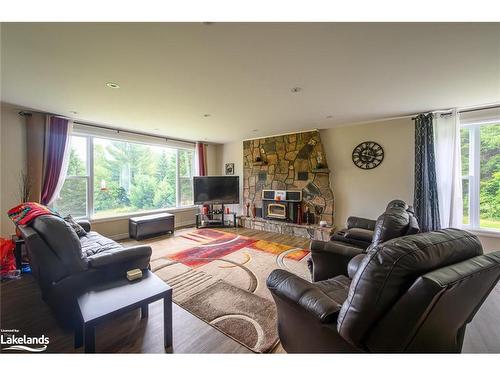 11 Gibson Road, Emsdale, ON - Indoor Photo Showing Living Room With Fireplace