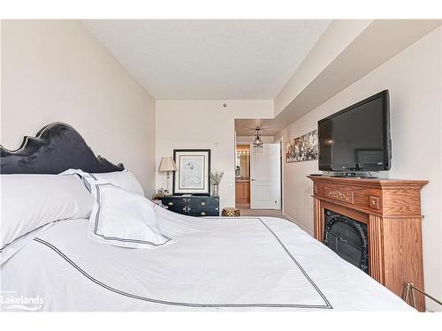 201-34 Bayfield Street, Meaford, ON - Indoor Photo Showing Bedroom With Fireplace