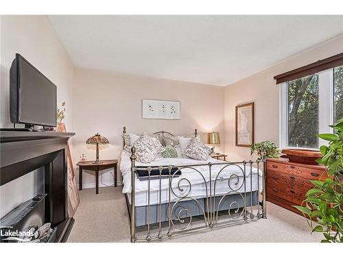 201-34 Bayfield Street, Meaford, ON - Indoor Photo Showing Bedroom With Fireplace