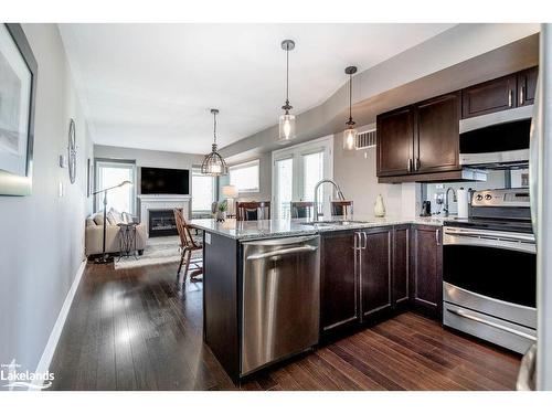 308-4 Brandy Lane Drive, Collingwood, ON - Indoor Photo Showing Kitchen With Fireplace With Stainless Steel Kitchen With Upgraded Kitchen