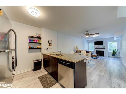 207-2 Brandy Lane Drive, Collingwood, ON - Indoor Photo Showing Kitchen With Fireplace With Double Sink