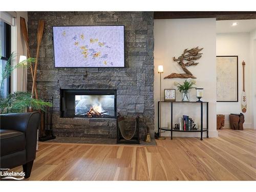 32 A11 Island, Pointe Au Baril, ON - Indoor Photo Showing Living Room With Fireplace