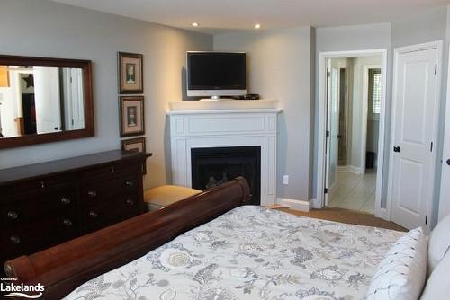 Carling 4 Week 9-3876 Muskoka Road 118 W, Port Carling, ON - Indoor Photo Showing Bedroom With Fireplace