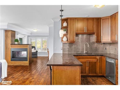 402-26 Dairy Lane, Huntsville, ON - Indoor Photo Showing Kitchen With Fireplace