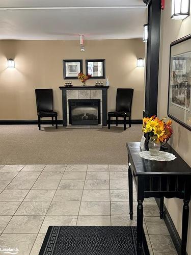 302-24 Dairy Lane, Huntsville, ON - Indoor Photo Showing Living Room With Fireplace