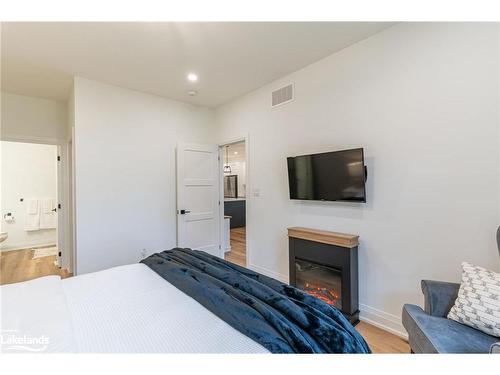 55 Jack Street, Huntsville, ON - Indoor Photo Showing Bedroom With Fireplace