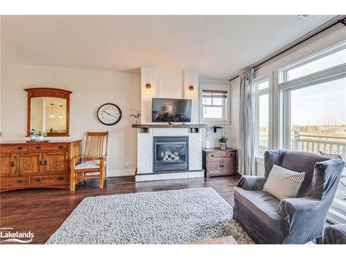 202-115 Fairway Court, Town Of Blue Mountains, ON - Indoor Photo Showing Living Room With Fireplace