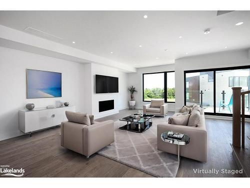 18-117 Sladden Court, Thornbury, ON - Indoor Photo Showing Living Room With Fireplace