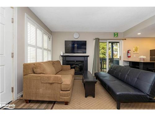 303-796468 Grey Road 19, The Blue Mountains, ON - Indoor Photo Showing Living Room With Fireplace