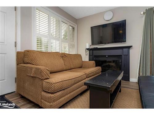 303-796468 Grey Road 19, The Blue Mountains, ON - Indoor Photo Showing Living Room With Fireplace