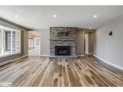 61 Beaufort Crescent, Tiny, ON - Indoor Photo Showing Living Room With Fireplace