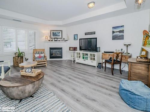 208-130 Steamship Bay Road, Gravenhurst, ON - Indoor Photo Showing Living Room With Fireplace