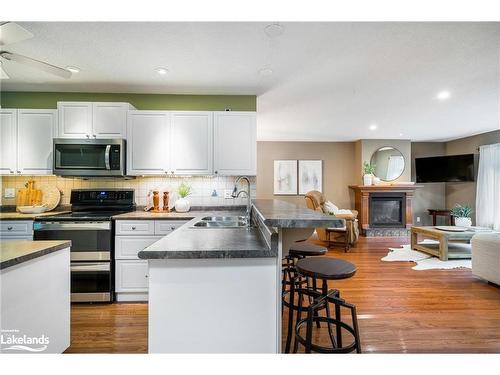 84 Wasaga Sands Drive, Wasaga Beach, ON - Indoor Photo Showing Kitchen With Fireplace