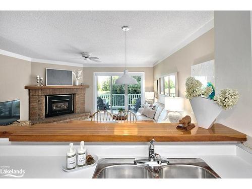 9-2 Ramblings Way, Collingwood, ON - Indoor Photo Showing Kitchen With Fireplace With Double Sink