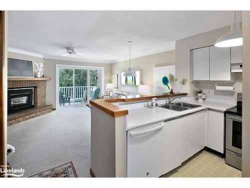 9-2 Ramblings Way, Collingwood, ON - Indoor Photo Showing Kitchen With Fireplace With Double Sink