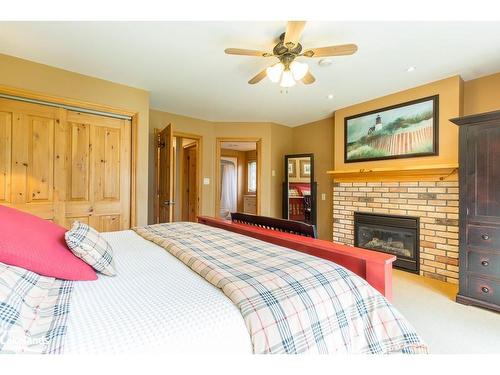 8, Fixed W-1111 Dwight Beach Road, Lake Of Bays, ON - Indoor Photo Showing Bedroom With Fireplace