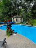 61 Woodland Drive N, Bracebridge, ON  - Outdoor With In Ground Pool With Deck Patio Veranda With Backyard 