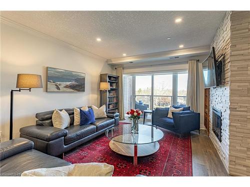 405-235 John Street N, Stratford, ON - Indoor Photo Showing Living Room With Fireplace