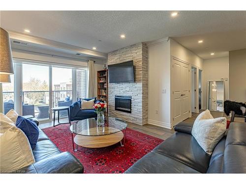 405-235 John Street N, Stratford, ON - Indoor Photo Showing Living Room With Fireplace