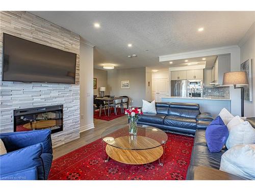 405-235 John Street N, Stratford, ON - Indoor Photo Showing Living Room With Fireplace