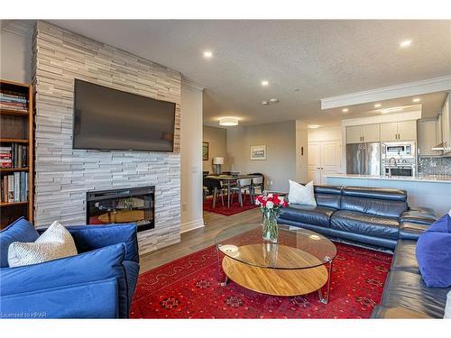 405-235 John Street N, Stratford, ON - Indoor Photo Showing Living Room With Fireplace