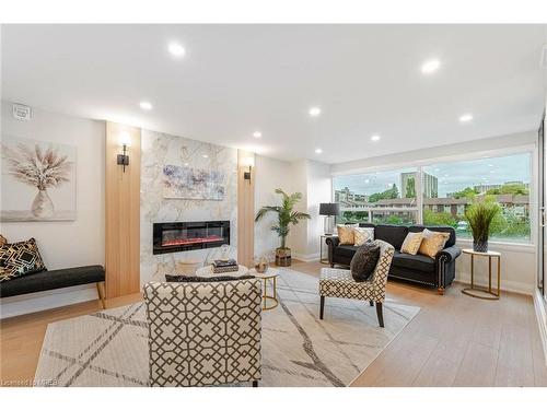 214-475 The West Mall, Toronto, ON - Indoor Photo Showing Living Room With Fireplace