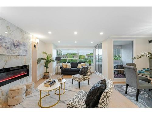 214-475 The West Mall, Toronto, ON - Indoor Photo Showing Living Room With Fireplace