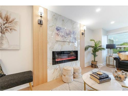 214-475 The West Mall, Toronto, ON - Indoor Photo Showing Living Room With Fireplace