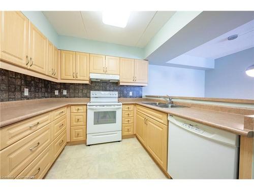 208-333 Lafontaine Road W, Tiny, ON - Indoor Photo Showing Kitchen With Double Sink