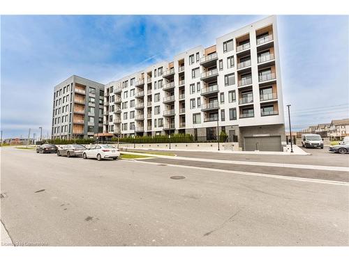 407-1440 Clarriage Court, Milton, ON - Outdoor With Balcony With Facade