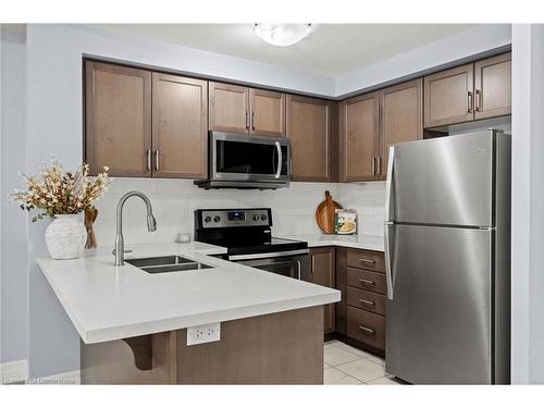 203-650 Sauve Street, Milton, ON - Indoor Photo Showing Kitchen With Stainless Steel Kitchen With Double Sink With Upgraded Kitchen