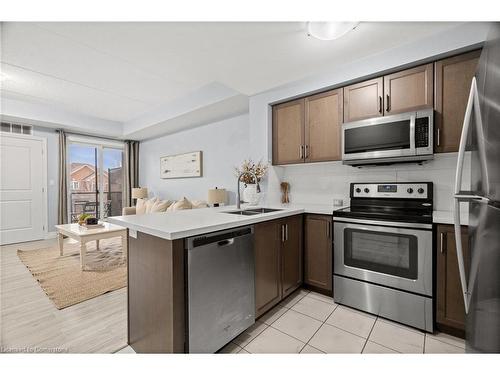 203-650 Sauve Street, Milton, ON - Indoor Photo Showing Kitchen With Stainless Steel Kitchen With Double Sink